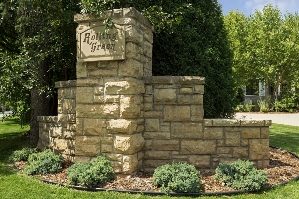 Rolling green neighborhood welcome sign.